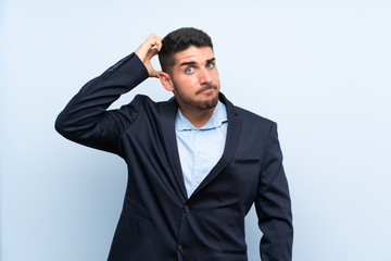 Handsome man over isolated blue background with an expression of frustration and not understanding