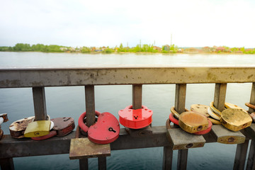 Lock for couple make a promise to love forever, master keys are hanging on the rails of bridge, the sign of love and romantic affection as a landmark of Irkutsk, Russia.