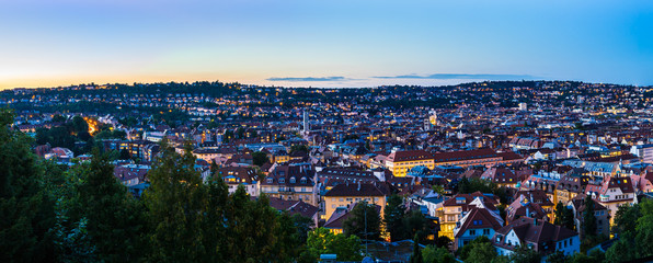 Germany, XXL panorama of sunset sky over urban cityscape of stuttgart city houses and roofs, aerial...