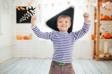 Boy in a pirate costume celebrates Halloween at home.