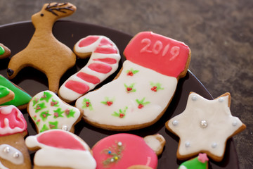 Festive family fun. Homemade Chritstmas gingerbread cookie made with various cookie cutters and decorated with icing and sprinkles