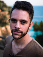 Fototapeta premium Spanish man posing for a portrait near the coast