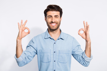 Fototapeta premium Photo of amazing mixed race handsome guy showing okey symbols approving good quality of product wear casual denim shirt isolated white color background
