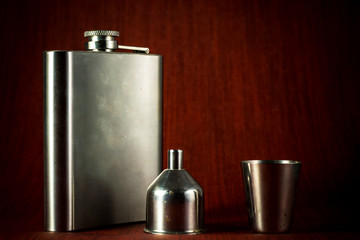 Metallic container for liquid, alcohol, whiskey and cognac. Old classic pocket vessel.