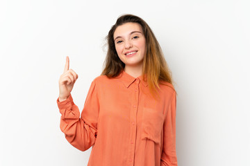 Young brunette girl over isolated white background showing and lifting a finger in sign of the best