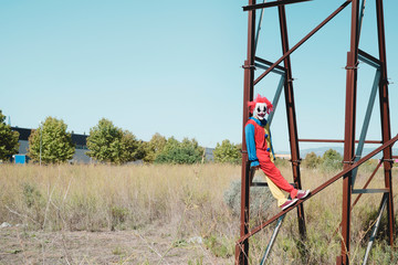 Fototapeta na wymiar scary clown on an abandoned billboard.