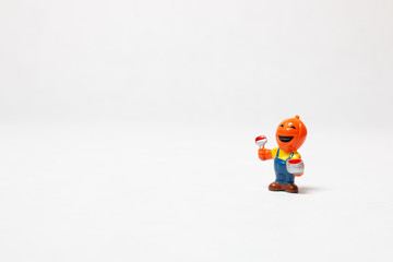 pumpkin-headed toy on white background