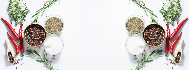 Long wide banner with different aromatic spices, herbs and sea salt on white background. Template...