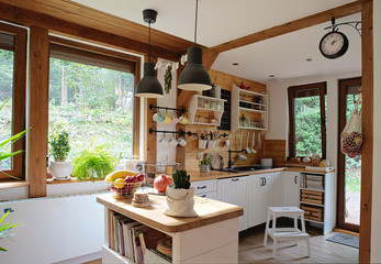 interior of modern kitchen in vintage style with white wooden furniture and rustic detail. Bright...