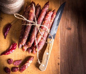 Thin uncooked smoked pork and beef sausages. Delicatessen meat.