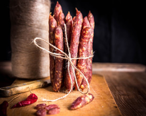 Thin uncooked smoked pork and beef sausages. Delicatessen meat.