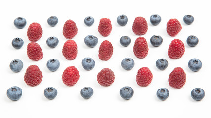 raspberries and blueberries on a white background. Vitamins and wholesome foods