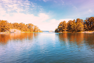 Beautiful landscape lake island with autumn orange yellow trees leaves over sky background