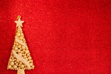 Naklejka na ściany i meble Holiday card for the Christmas holidays. Golden Christmas tree on a red background.