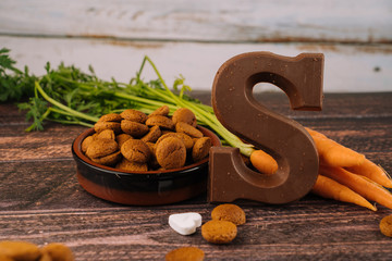 Dutch holiday Sinterklaas. Background with traditional food - pepernoten, chocolate letter, sweets strooigoed and carrots for horse. Concept for children party in Saint Nicolas day five december.