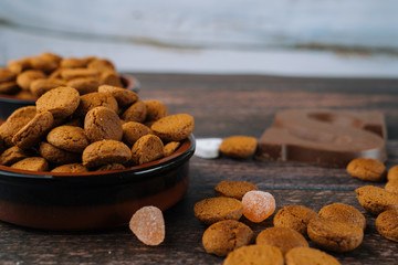 Dutch holiday Sinterklaas. Background with traditional food - pepernoten, chocolate letter, sweets strooigoed and carrots for horse. Concept for children party in Saint Nicolas day five december.