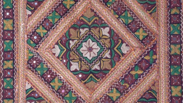 Detail old colorful patchwork carpet, establishing shot. Close up