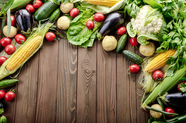 Fresh Organic Vegetable Food Ingredients on Wooden kitchen table background. Space for text.