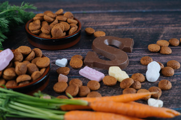 Dutch holiday Sinterklaas. Background with traditional food - pepernoten, chocolate letter, sweets strooigoed and carrots for horse. Concept for children party in Saint Nicolas day five december.