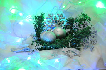 New Year's balls in silver color as a decoration on the Christmas tree