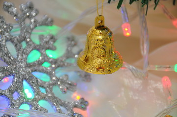 New Year's bells in red and gold color as a decoration on the christmas tree