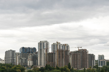 Fototapeta premium Buildings under construction. Lifting cranes