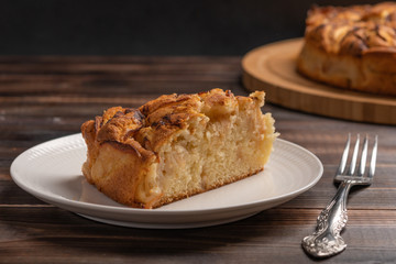 Piece of homemade traditional cornish apple pie on a white plate. Close up. Selective focus