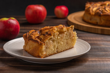 Piece of homemade traditional cornish apple pie on a white plate. Close up