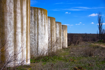 View of the concrete columns of the building, against the backdrop of architecture. concrete...