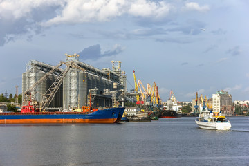 Naklejka premium Elevating complex for transshipment of grain and oilseeds as part of a reloading terminal. Transportation of agricultural products and port cranes