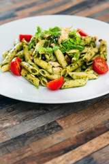 Pasta with pesto sauce and nuts on a the table