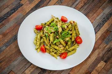 Pasta with pesto sauce and nuts on a the table