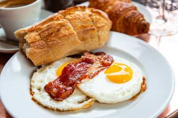 Breakfast with coffee and croissants on table