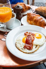 Breakfast with coffee and croissants on table