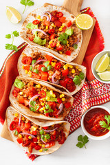 mexican beef and pork tacos with salsa, guacamole and vegetables