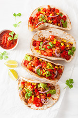 mexican beef and pork tacos with salsa, guacamole and vegetables