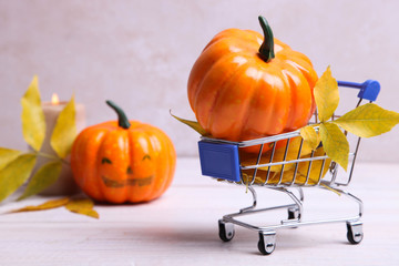 Pumpkin and dry leaves in supermarket trolly