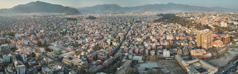 Panoramic view from the drone to the capital of Nepal, Kathmandu. Sunset cityscape in Thamel...