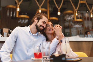 Young happy couple at date in a cafe