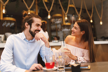 Young happy couple at date in a cafe