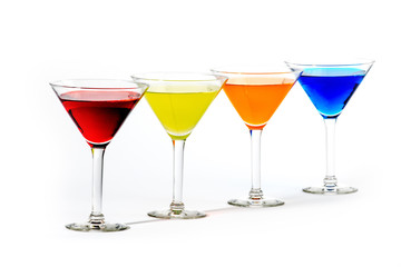 martini glasses with colorful cocktails isolated on white