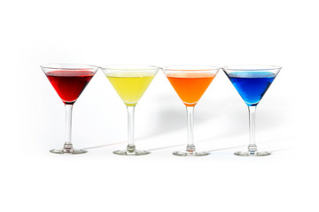 martini glasses with colorful cocktails isolated on white