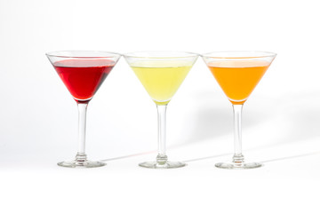martini glasses with colorful cocktails isolated on white