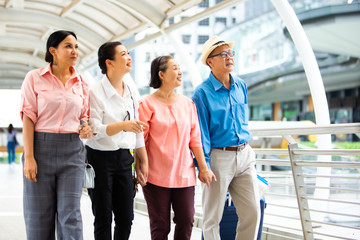 Travel and tourism concept.Group of senior people traveling in the city and looking the map in hand for Shopping Mall Search