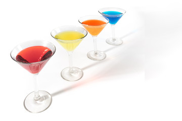 martini glasses with colorful cocktails isolated on white
