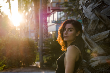 Portrait of a young woman in a park of a city