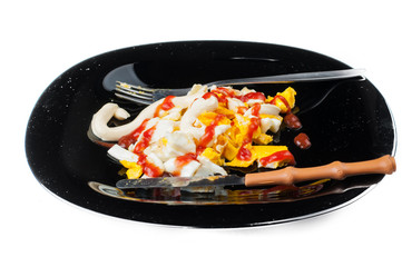 Fried egg on black plate isolated on white background.Eggs with kutchup,olives and bread