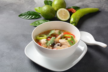 Thai style coconut milk soup-Tom Kha Gai with chicken,mushrooms, galangal, lime leaves, lemongrass, chili peppers. Thai cuisine food concept