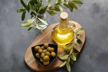 Extra virgin Olive oil , olive branch and olives on a dark background