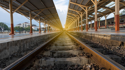 Low view of the railroad with a light of orange